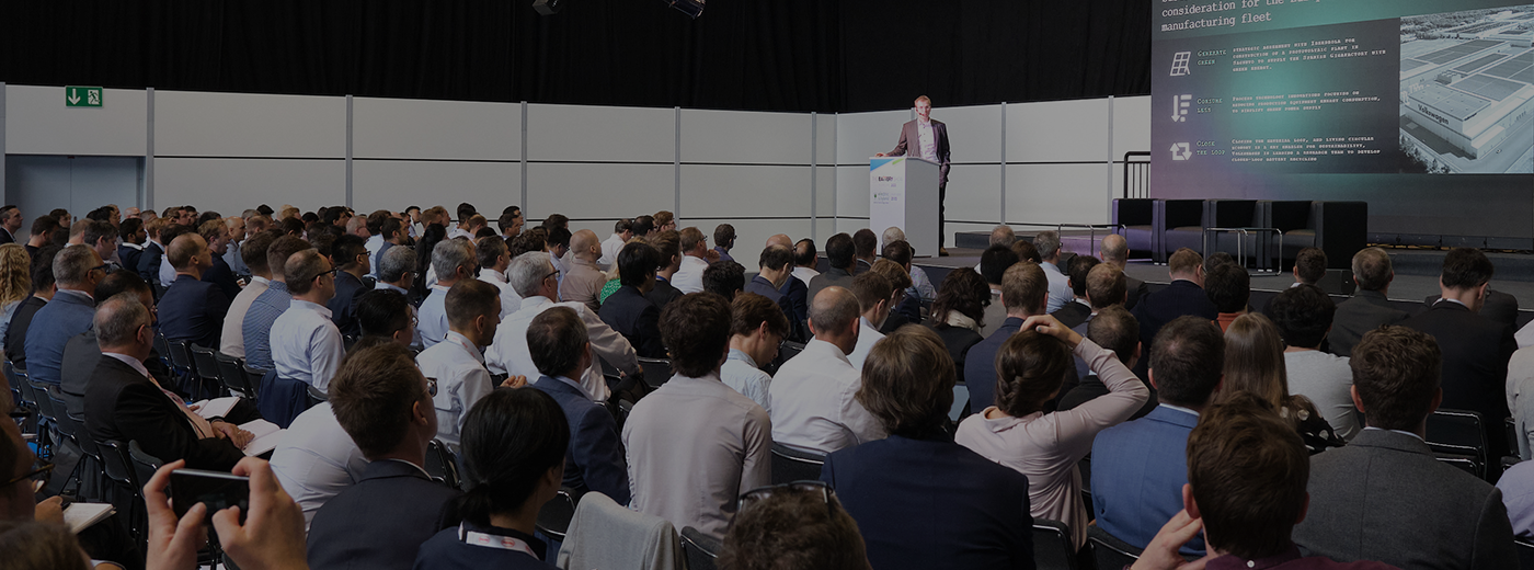 Conference Speaker giving a presentation to a large crowd on European cell manufacturing fleet
